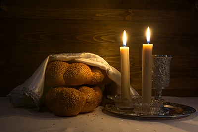 Challah bread and candles on a table Challah bread and candles on a table