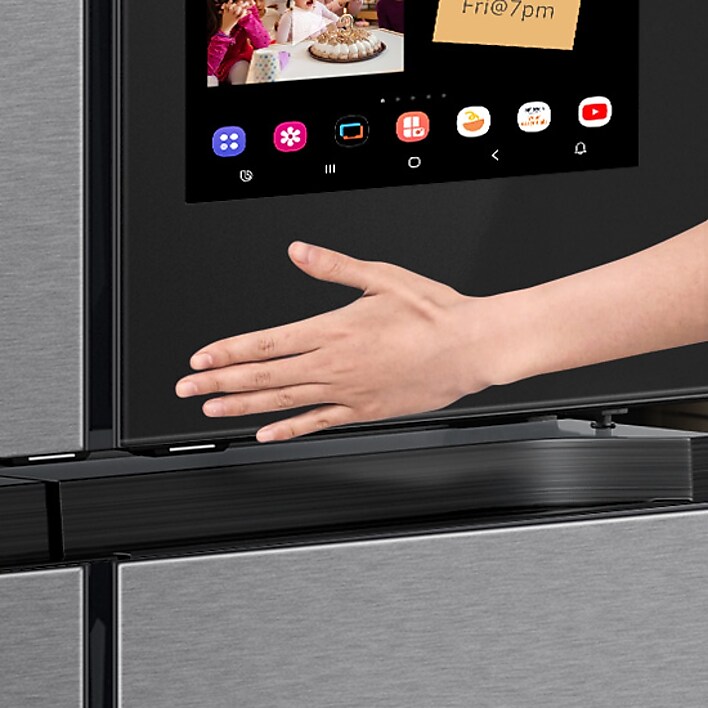 Persons hand using touch screen on Samsung Family Hub refrigerator Persons hand using touch screen on Samsung Family Hub refrigerator