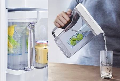 Person pouring water from Auto Fill Pitcher Person pouring water from Auto Fill Pitcher
